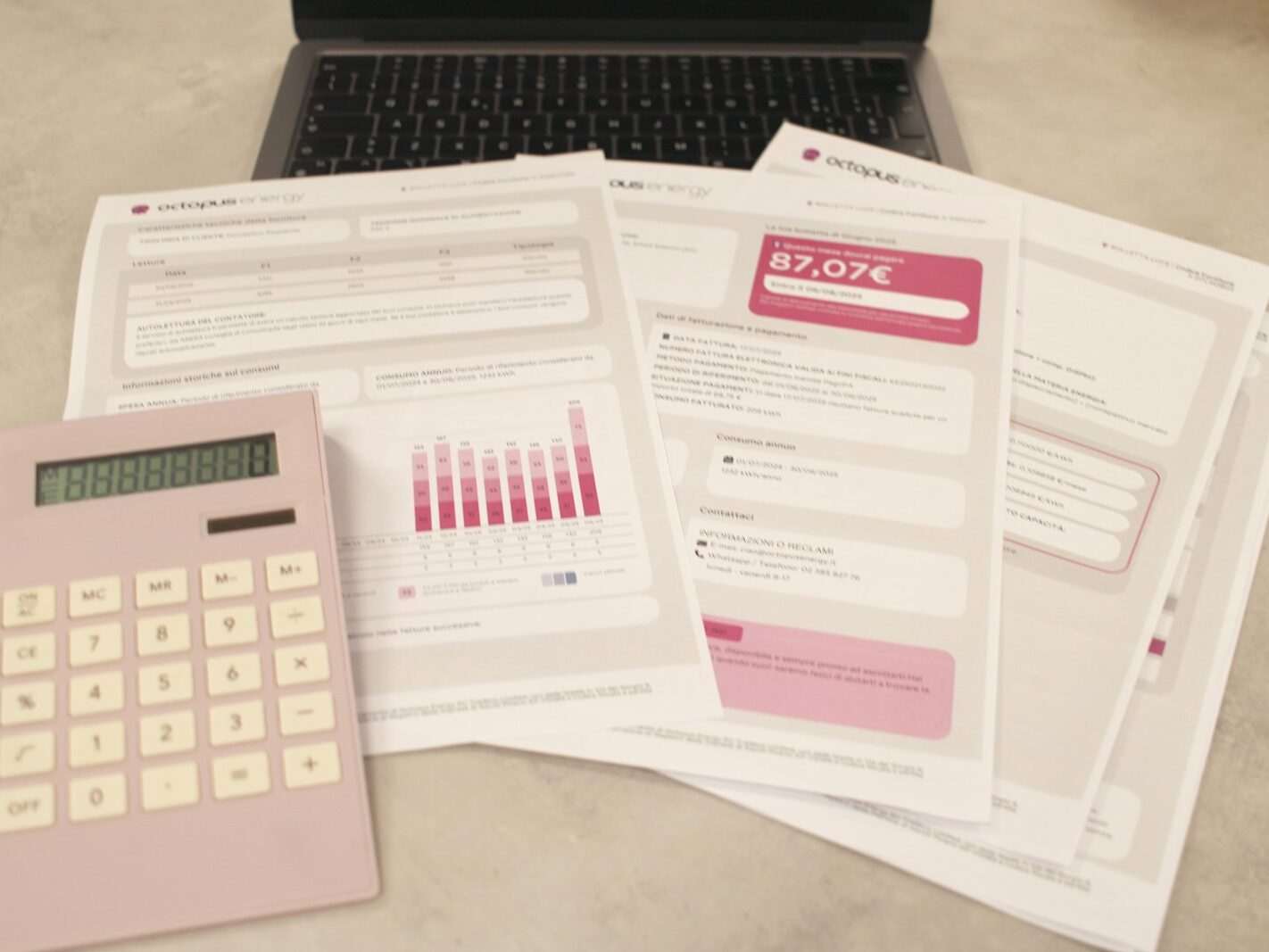 Bills, calculator, and a laptop: financial tasks underway.
